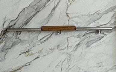 Stainless steel grab bars installed inside a walk-in shower for stability