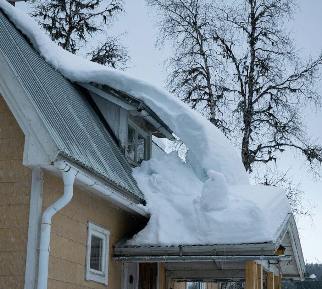 Roof-raking the lower roof from the ground to reduce ice dam risk