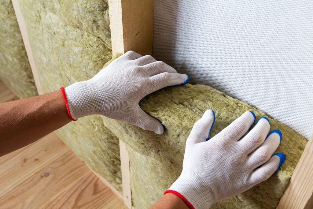 Cross-section of a Terre Haute basement wall showing rigid foam on concrete, 2×4 service wall, smart vapor retarder, and drywall