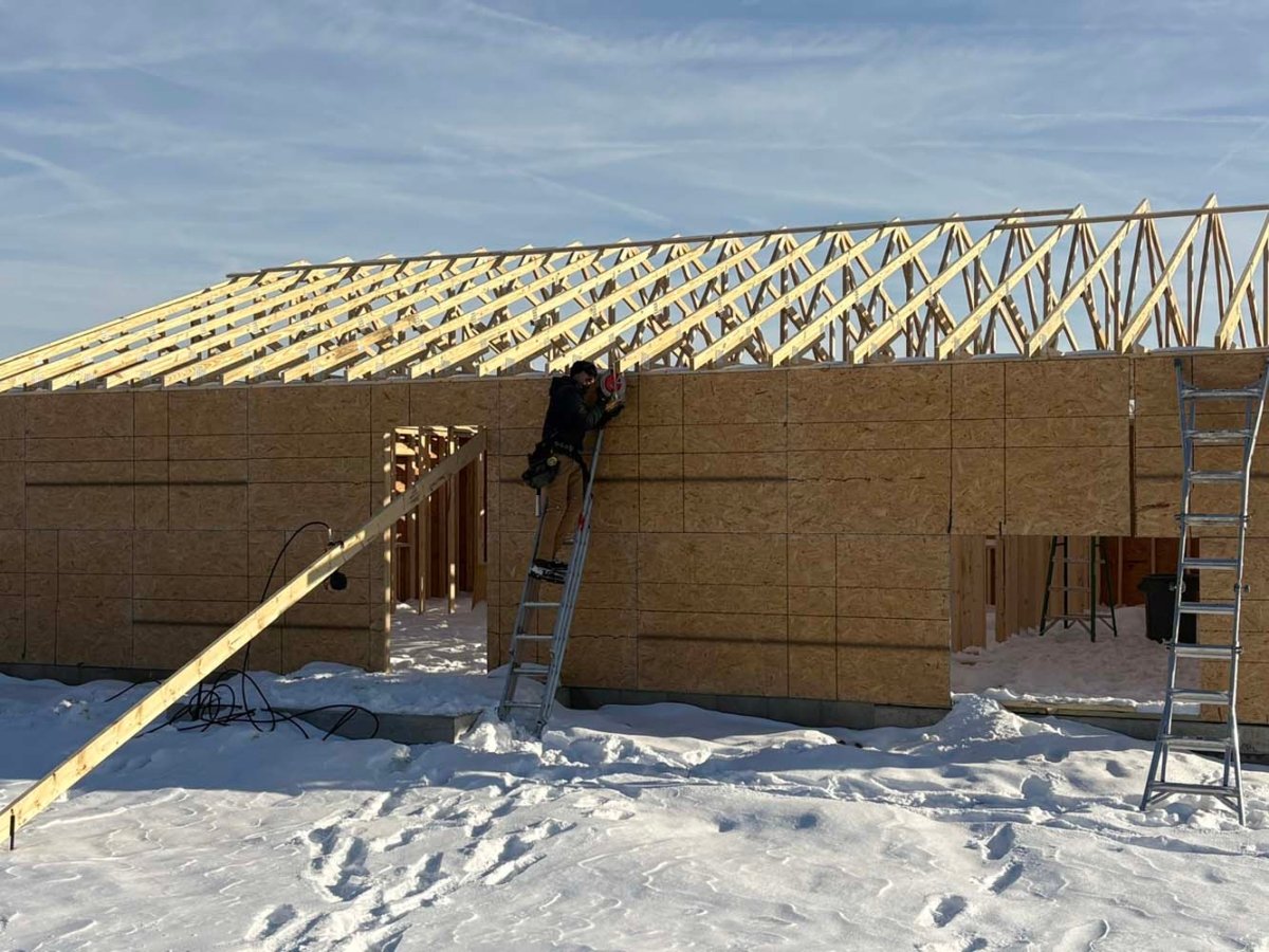 cutting the end of trusses to make sure fascia board is installed straight