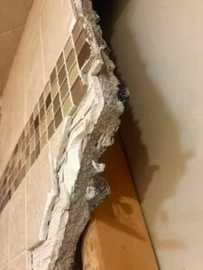 Thick mud bed walls and 2 layers of tile during demo