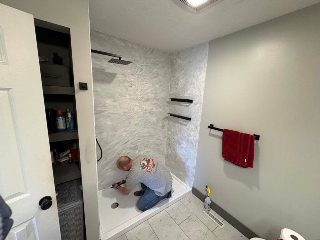 Grout-free solid surface shower wall system installed in a Terre Haute area bathroom remodel