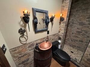 vanity with goblets and candle lights and main light on